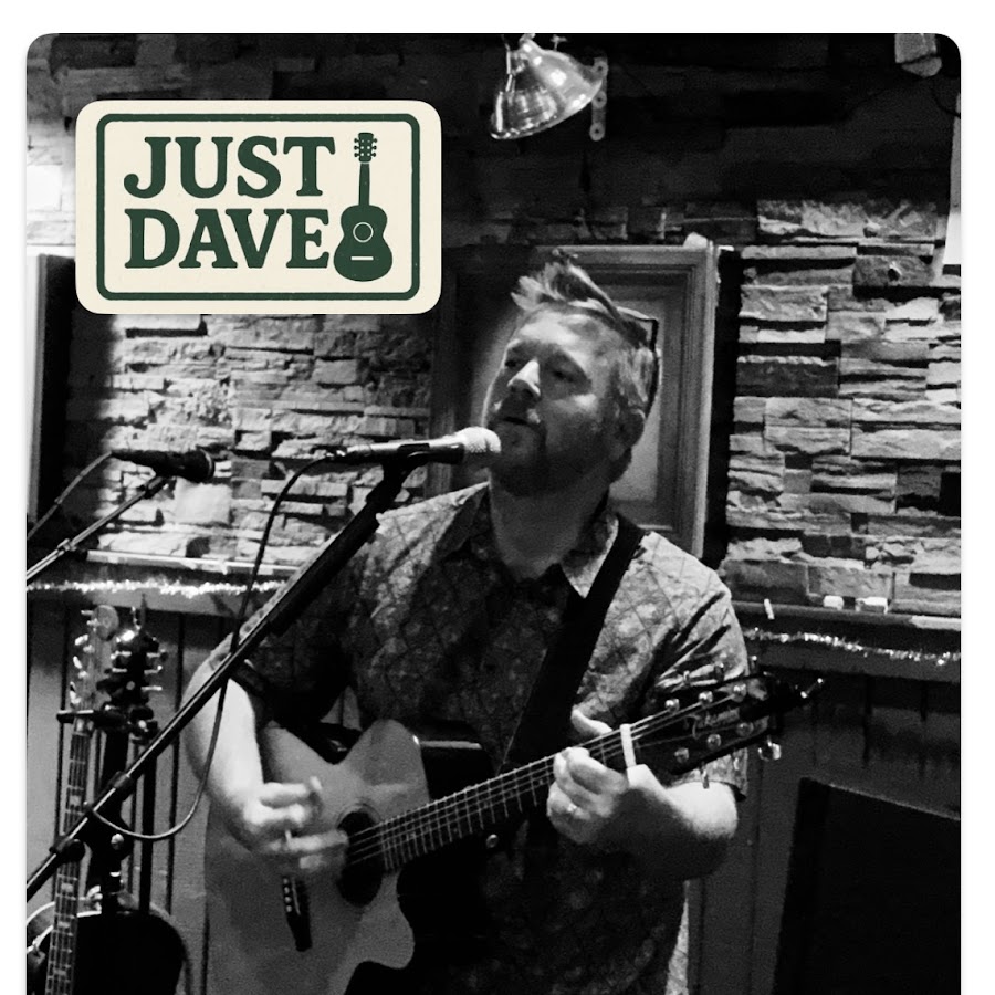 Just Dave singing and playing acoustic guitar, with his cream and dark green logo